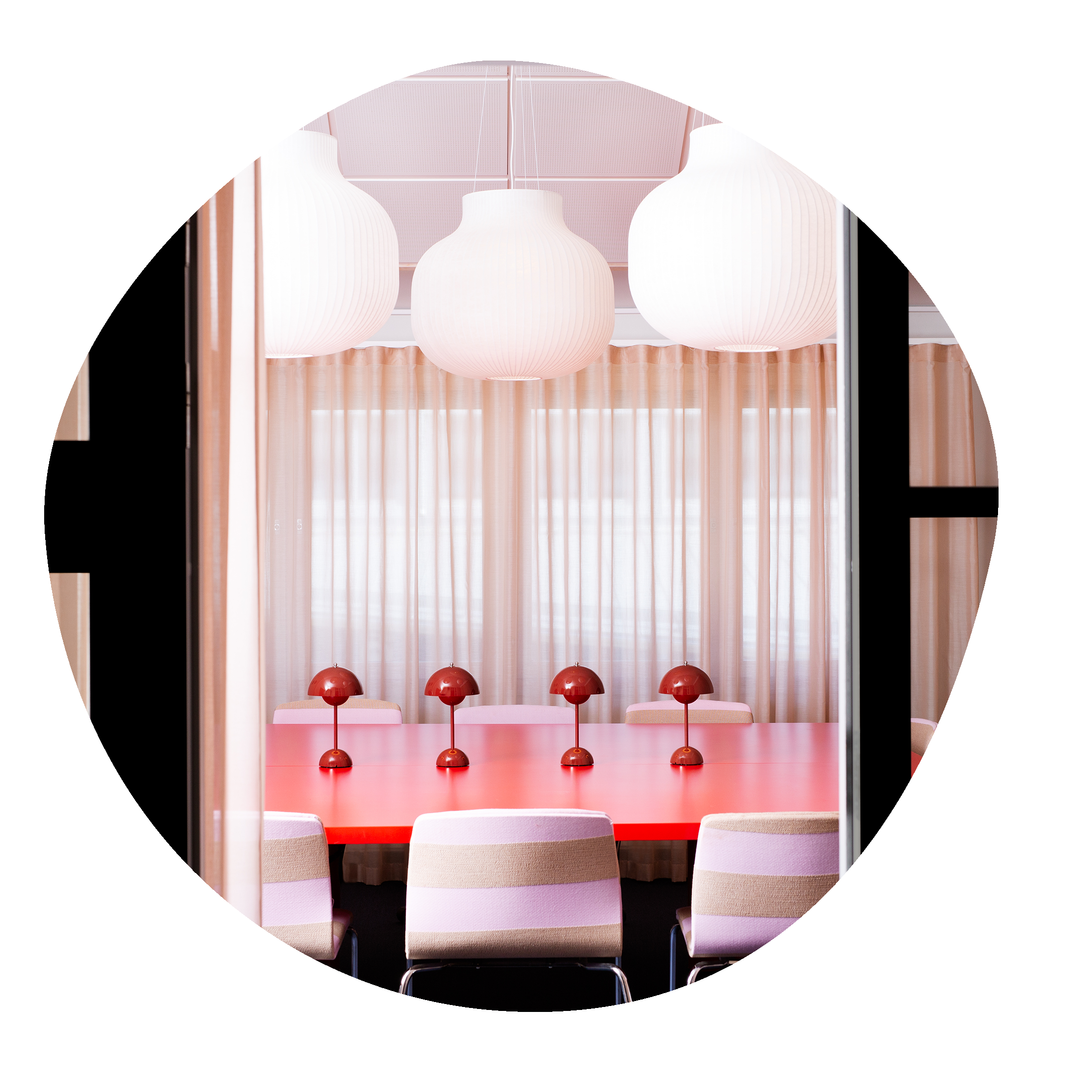 Öppning till konferensrum i rosa toner med små bordslampor.